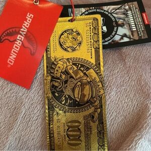 Sprayground Gold Money Bookmark